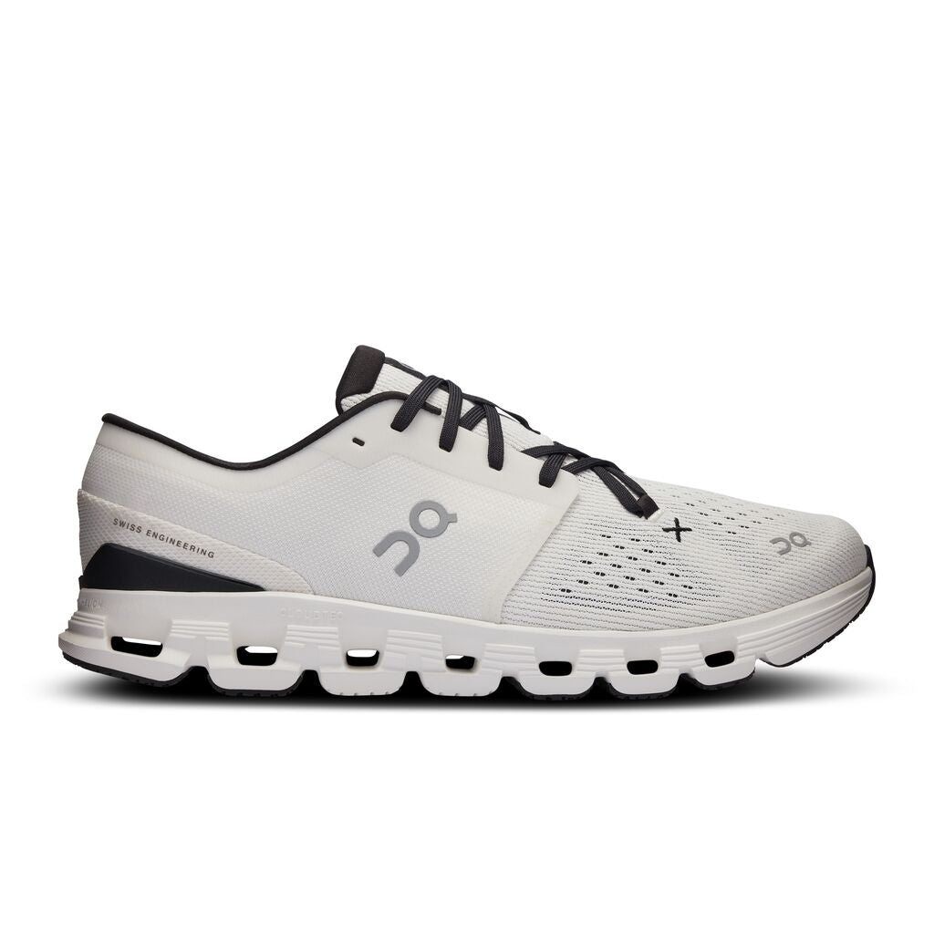 On Cloud X 4 running shoe in ivory and black colorway with distinctive cloud sole