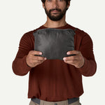 Patagonia Nano Puff Jacket packed into its own pocket in Forge Grey, compact size shown