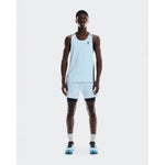 Athletic man wearing On running tank top and 2-in-1 shorts in arctic blue with midnight compression layer