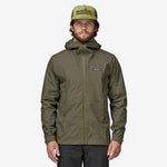 Man wearing Patagonia Boulder Fork Rain Jacket in olive green with hood