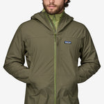 Man wearing Patagonia Boulder Fork Rain Jacket in olive green with hood up