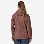 Woman wearing Patagonia Torrentshell 3L Rain Jacket in Dulse Mauve, back view