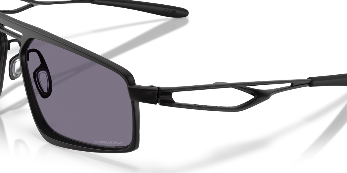 Oakley Bushwick sunglasses close-up of hinge and temple detail with grey Prizm lens