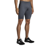 Man wearing Brooks Equip 9-inch running shorts in dark gray color