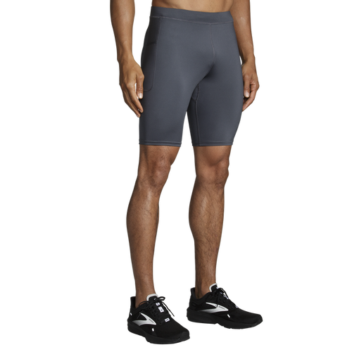 Man wearing Brooks Equip 9-inch running shorts in dark gray color
