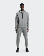 Man wearing gray On Focus Tech Hoodie and matching joggers on white background