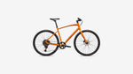 Orange Specialized Sirrus X 3.0 hybrid bike with disc brakes on white background
