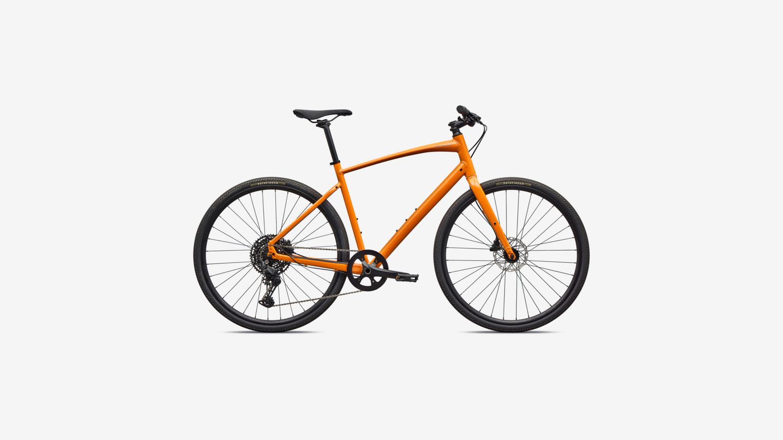 Orange Specialized Sirrus X 3.0 hybrid bike with disc brakes on white background
