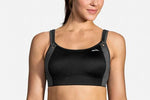 Woman wearing black Brooks Fiona sport bra with gray straps on clean background