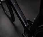 Close-up of X-LAB AD9 down tube showing brand text, UCI approval sticker and frame details