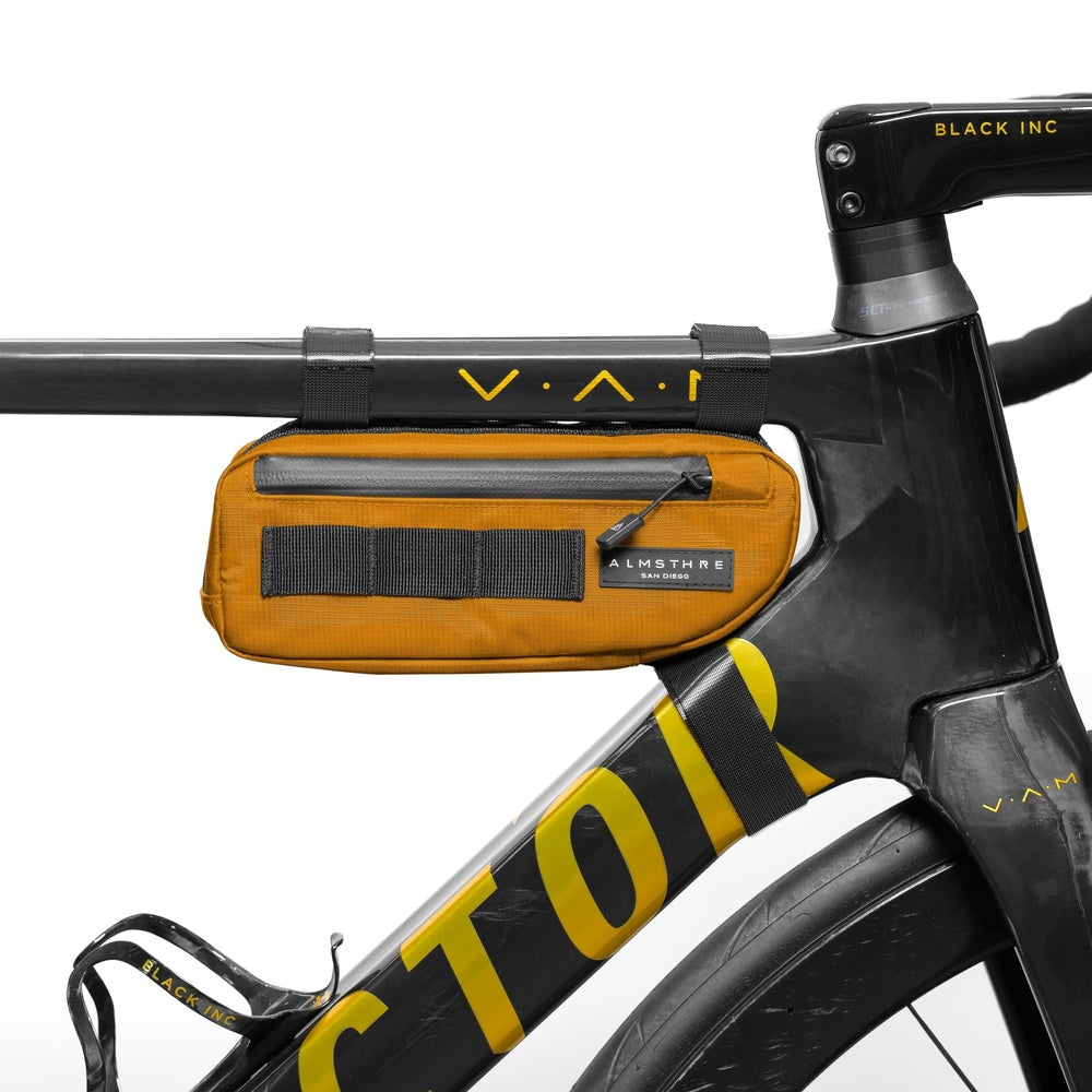Orange Almsthre compact frame bag mounted on black bicycle frame