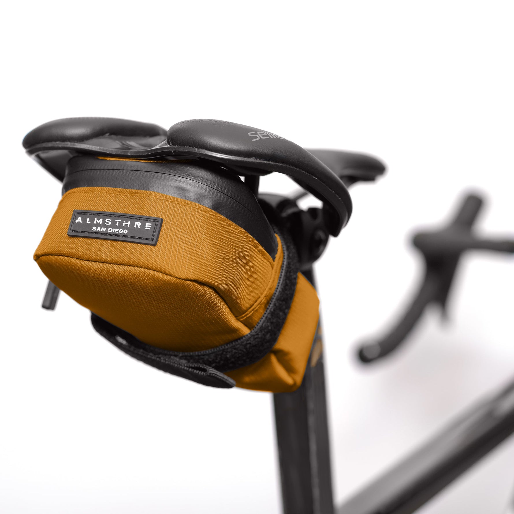 ALMSTHRE Signature Saddle Bag in California Gold attached to bicycle seat