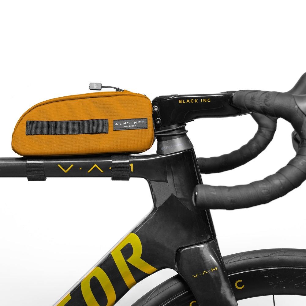 ALMSTHRE orange top tube bike bag mounted on black bicycle handlebars