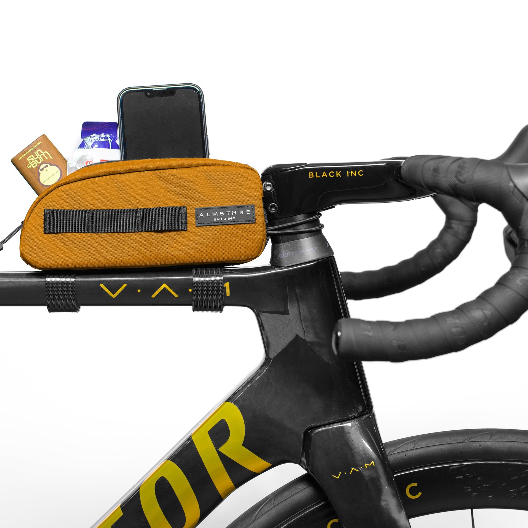 Orange ALMSTHRE top tube bike bag mounted on bicycle handlebars with phone and cards