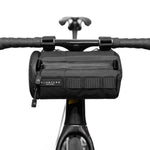 Black ALMSTHRE bicycle handlebar bag mounted on bike handlebars against white background