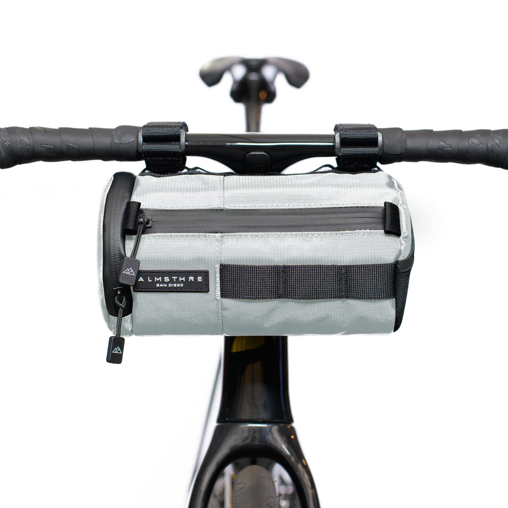 Gray ALMSTHRE handlebar bag mounted on bicycle handlebars with attachment straps