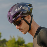 Professional cyclist wearing purple Kask Nirvana helmet with integrated visor during outdoor training