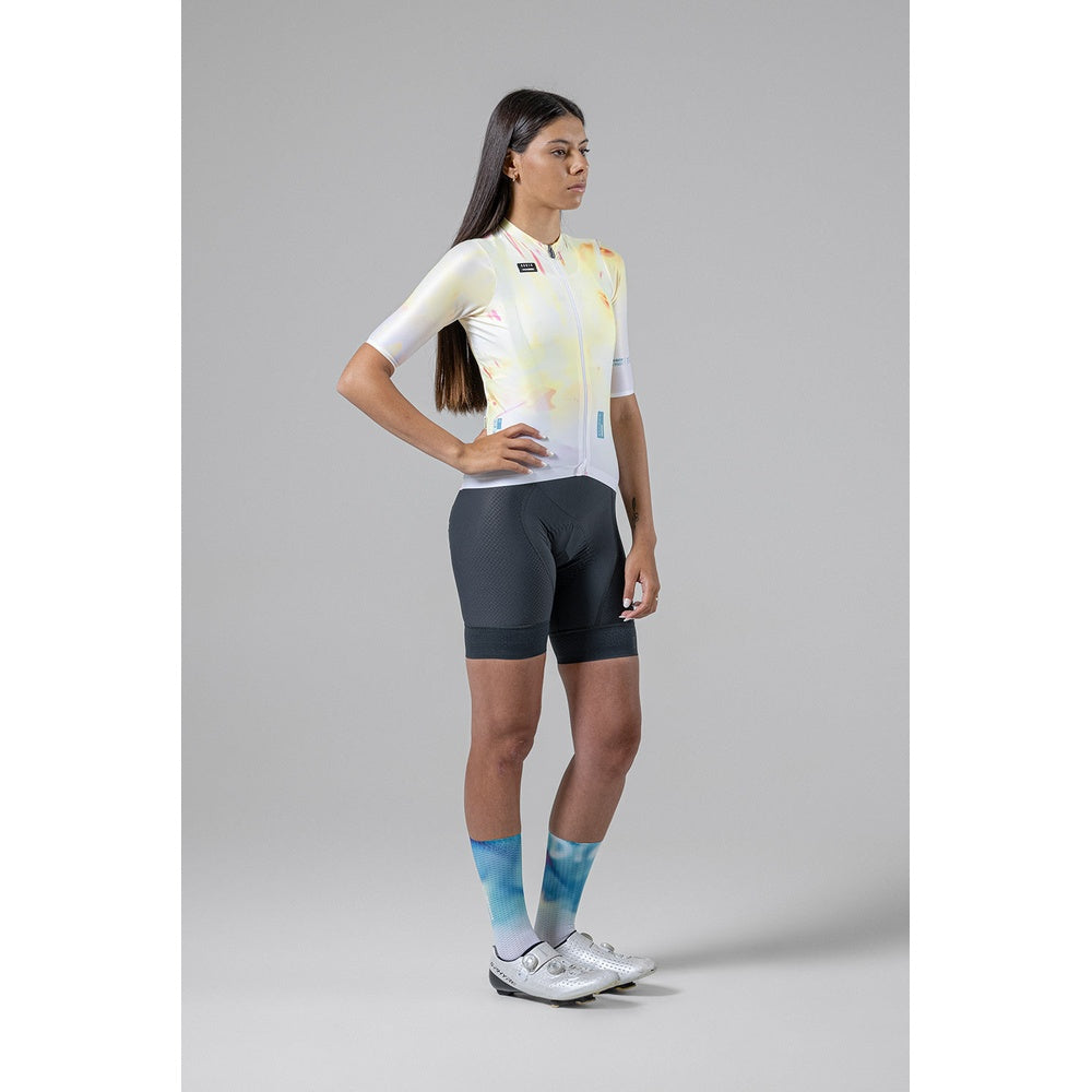 Woman wearing Gobik Absolute 5.0 bib shorts in slate gray with colorful cycling jersey