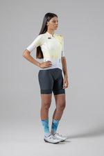 Woman wearing Gobik Absolute 5.0 bib shorts in slate gray with colorful cycling jersey