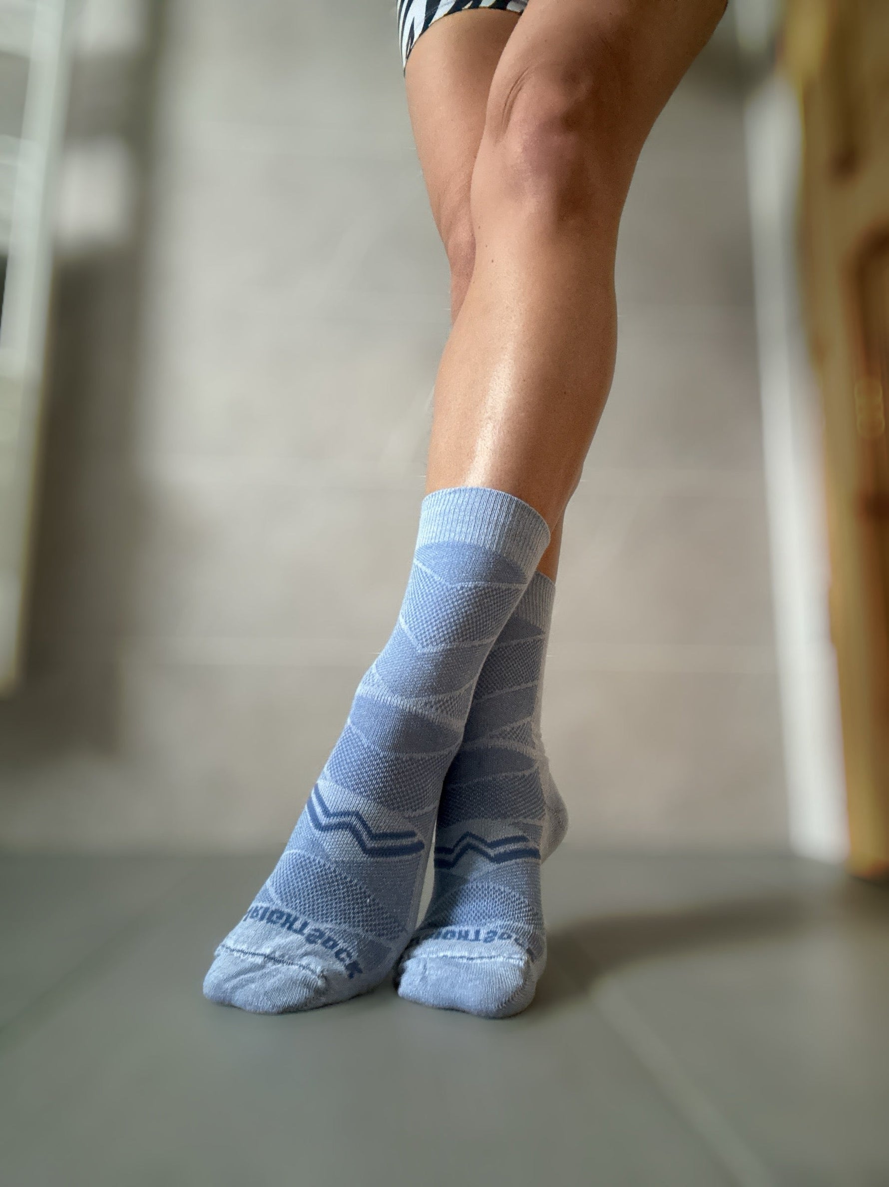 Wrightsock Coolmesh II crew length socks in cloud grey worn on feet