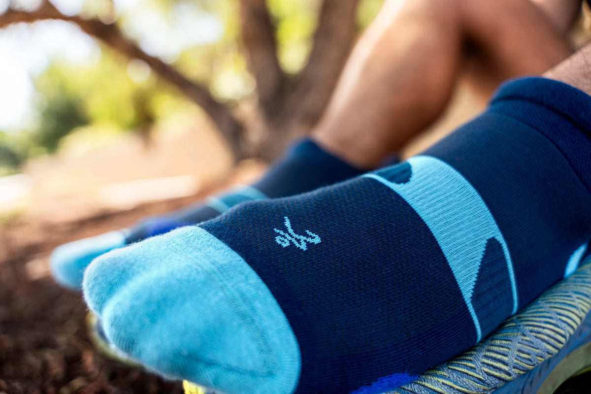 Balega navy blue no-show running sock with light blue heel and toe