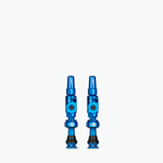 Two blue Muc-Off Big Bore Lite Tubeless Presta Valves on white background
