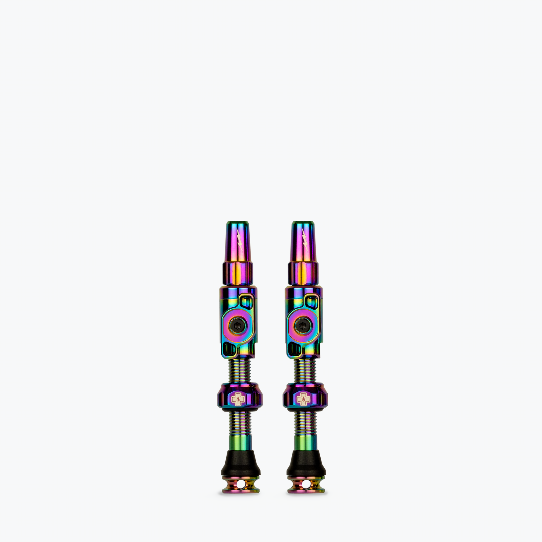 Two Muc-Off Big Bore Lite Tubeless Presta Valves with rainbow iridescent finish