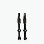 Two black Muc-Off Big Bore Lite tubeless Presta valves on white background