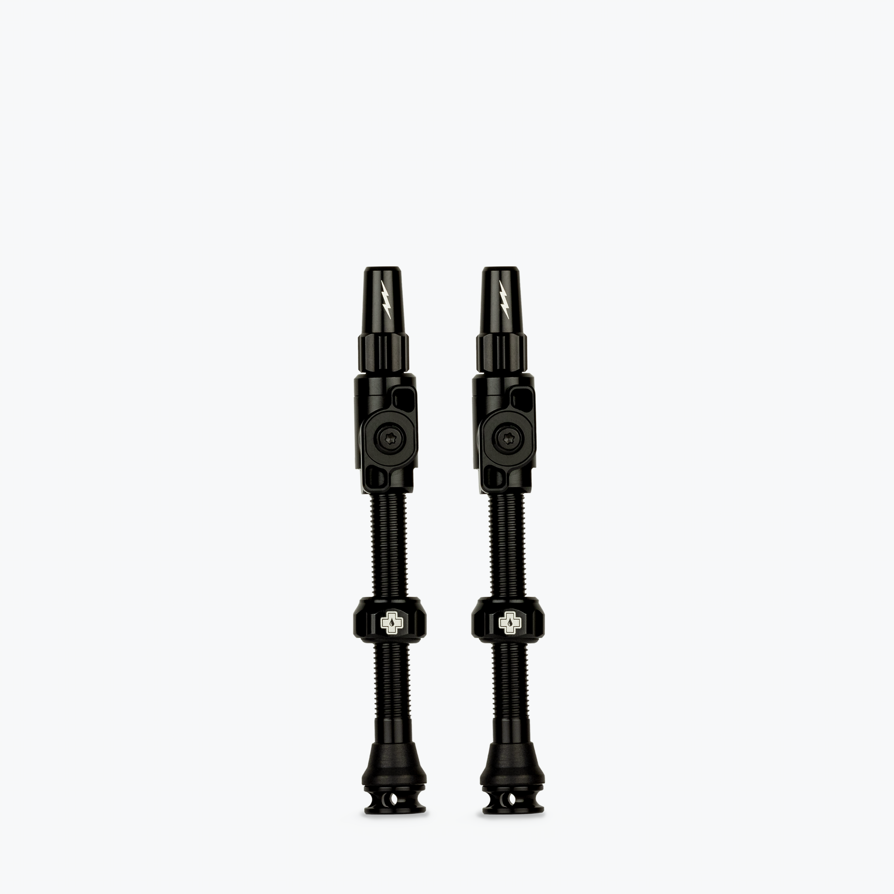 Two black Muc-Off Big Bore Lite tubeless Presta valves on white background