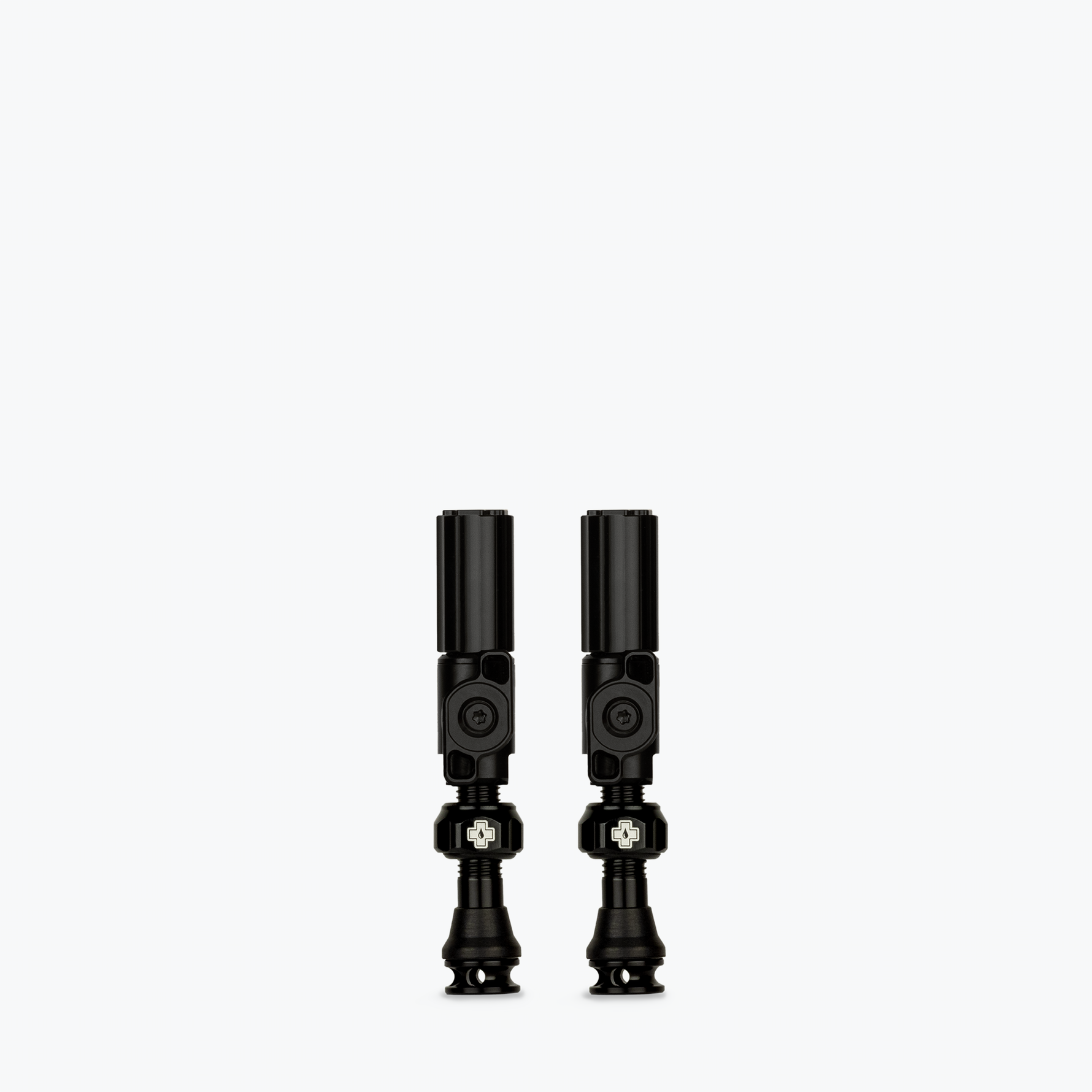 Two black Muc-Off Big Bore Hybrid Tubeless Presta Valves on white background