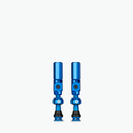 Pair of blue Muc-Off Big Bore Hybrid Tubeless Presta Valves on white background