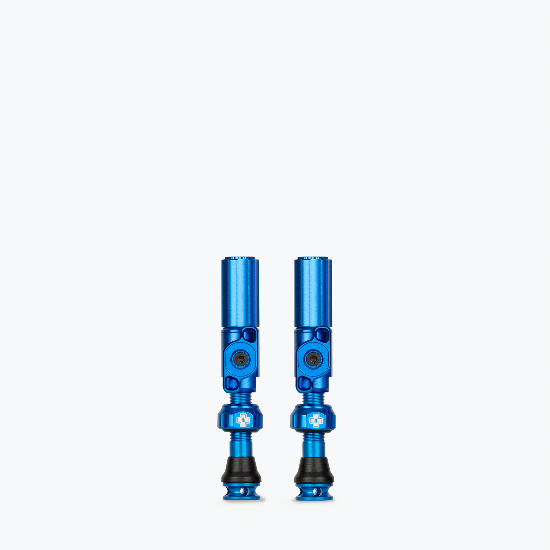 Pair of blue Muc-Off Big Bore Hybrid Tubeless Presta Valves on white background