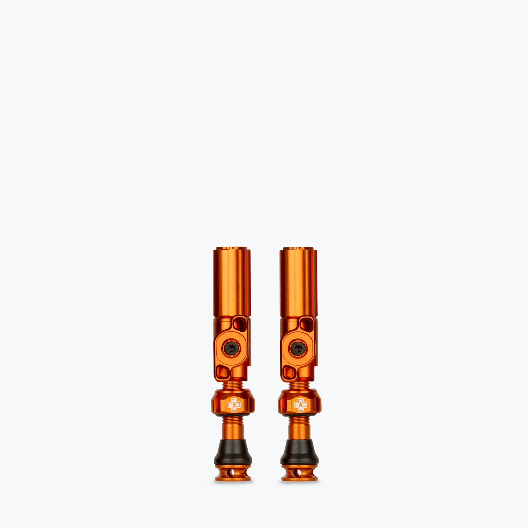 Two orange Muc-Off Big Bore Hybrid Tubeless Presta Valves on white background