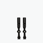 Two black Muc-Off Big Bore Hybrid Tubeless Presta Valves on white background