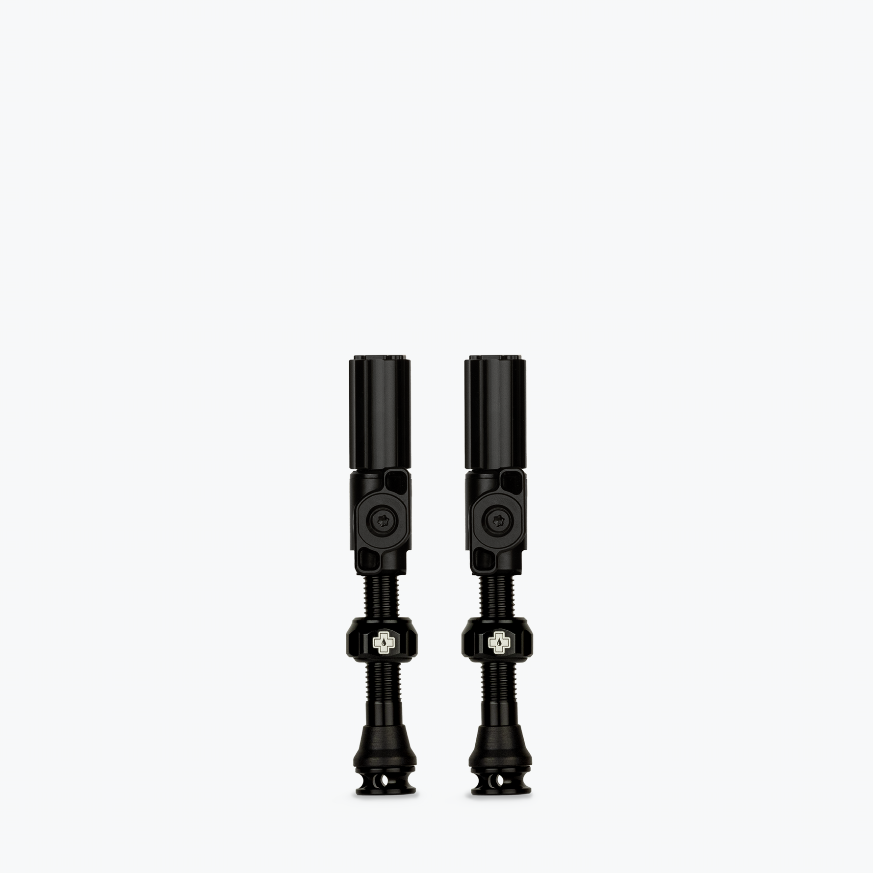 Two black Muc-Off Big Bore Hybrid Tubeless Presta Valves on white background