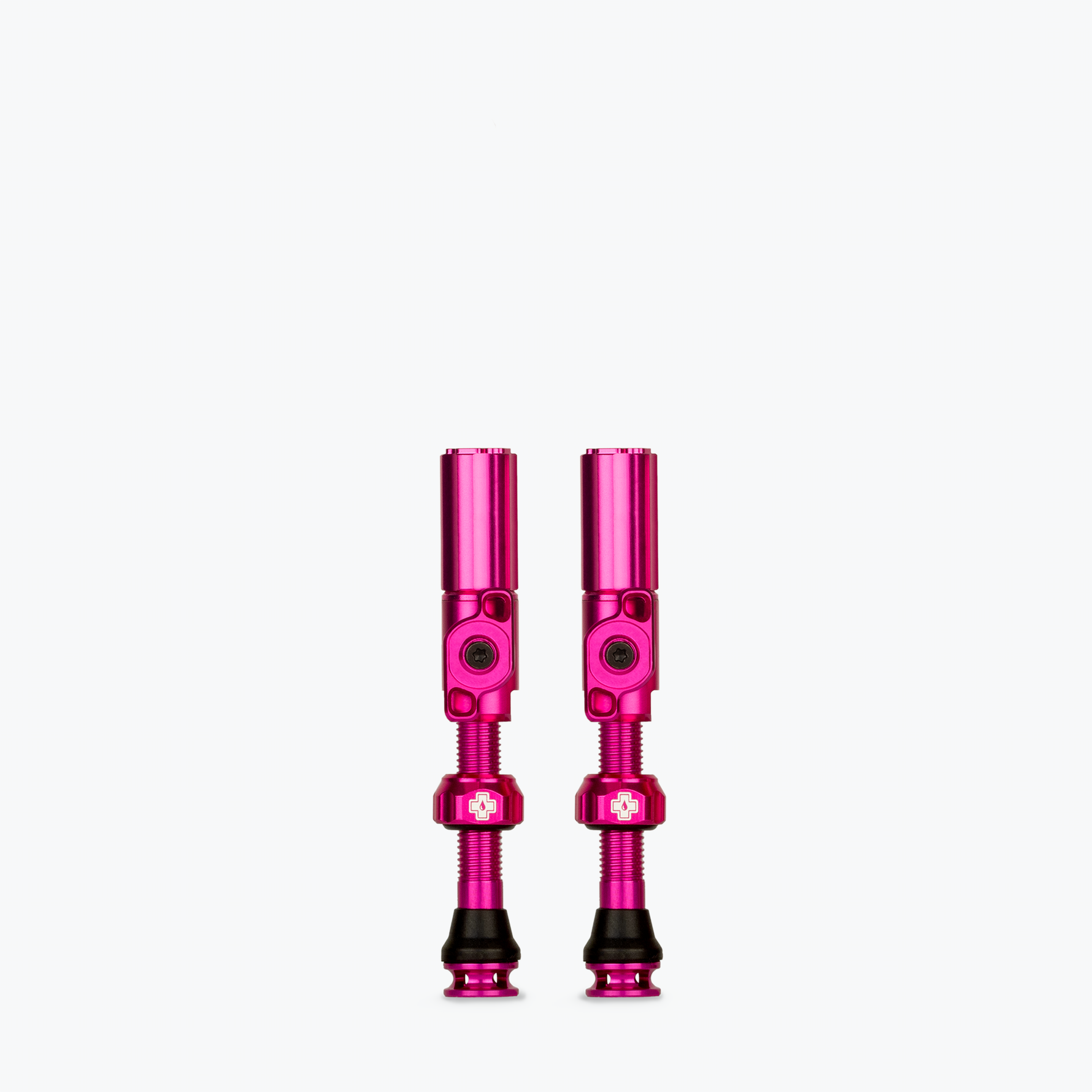 Two bright pink Muc-Off Big Bore Hybrid Tubeless Presta Valves with threaded stems
