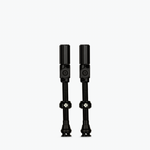 Two black Muc-Off Big Bore Hybrid Tubeless Presta Valves on white background