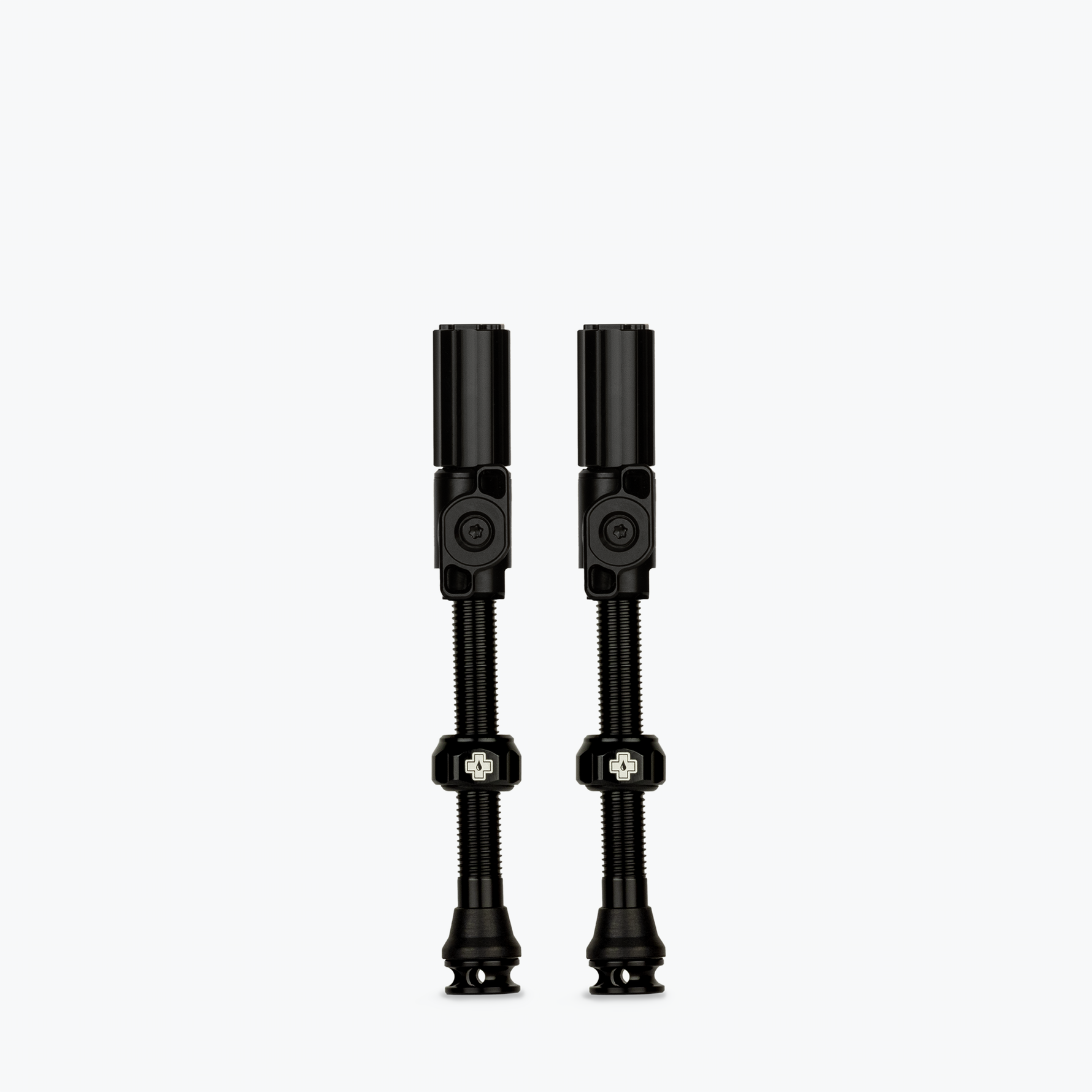 Two black Muc-Off Big Bore Hybrid Tubeless Presta Valves on white background