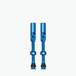 Two blue Muc-Off Big Bore Hybrid Tubeless Presta Valves on white background