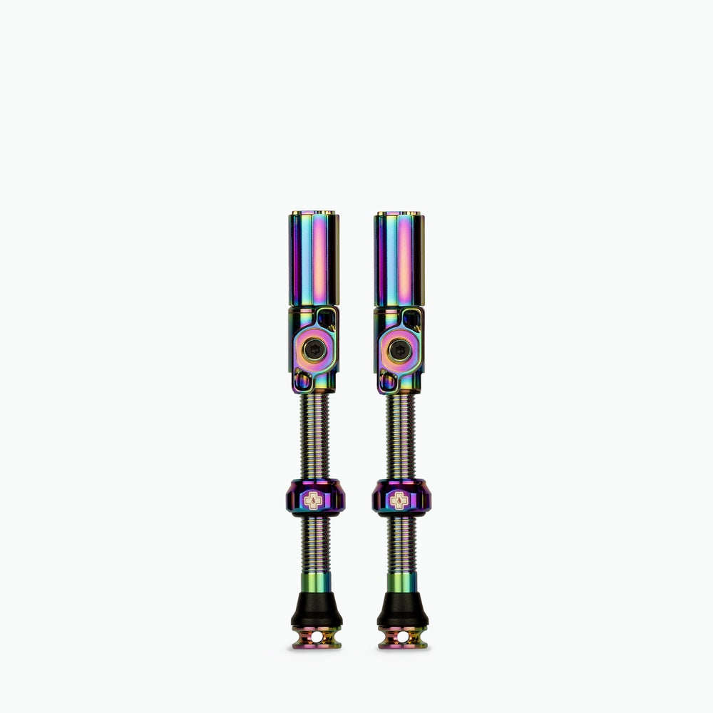 Two Muc-Off Big Bore Hybrid Tubeless Presta Valves with rainbow iridescent finish