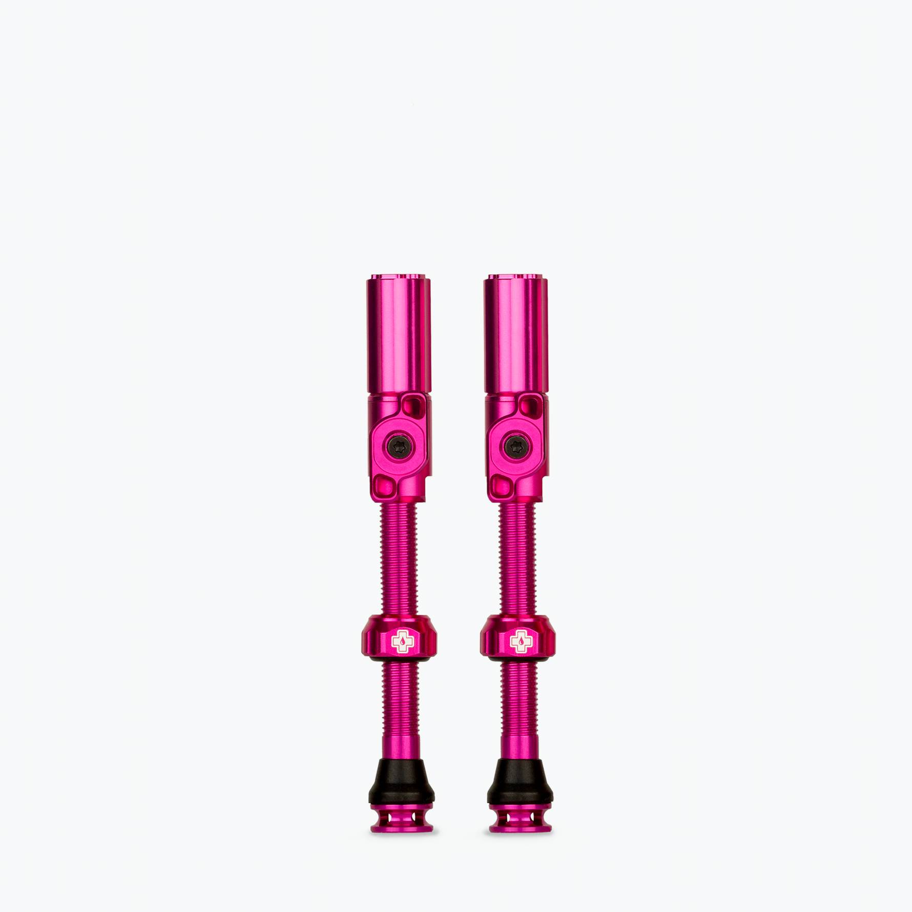 Two pink Muc-Off tubeless presta valves on white background