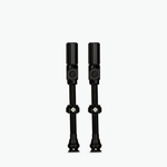 Two black Muc-Off Big Bore Hybrid Tubeless Presta Valves on white background