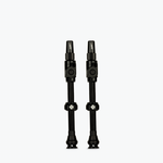 Two black Muc-Off Big Bore Lite tubeless Presta valves on white background