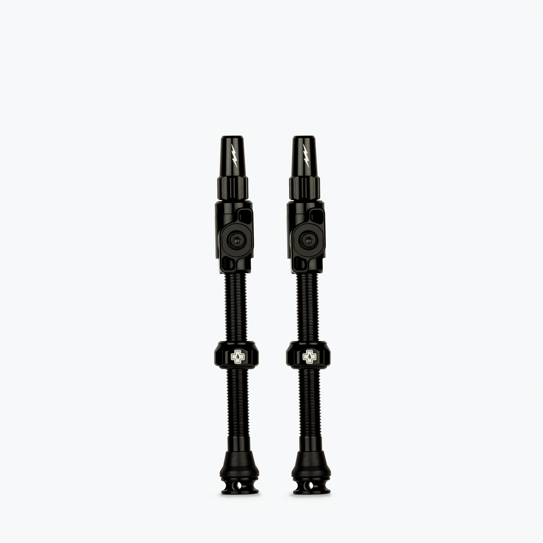 Two black Muc-Off Big Bore Lite tubeless Presta valves on white background