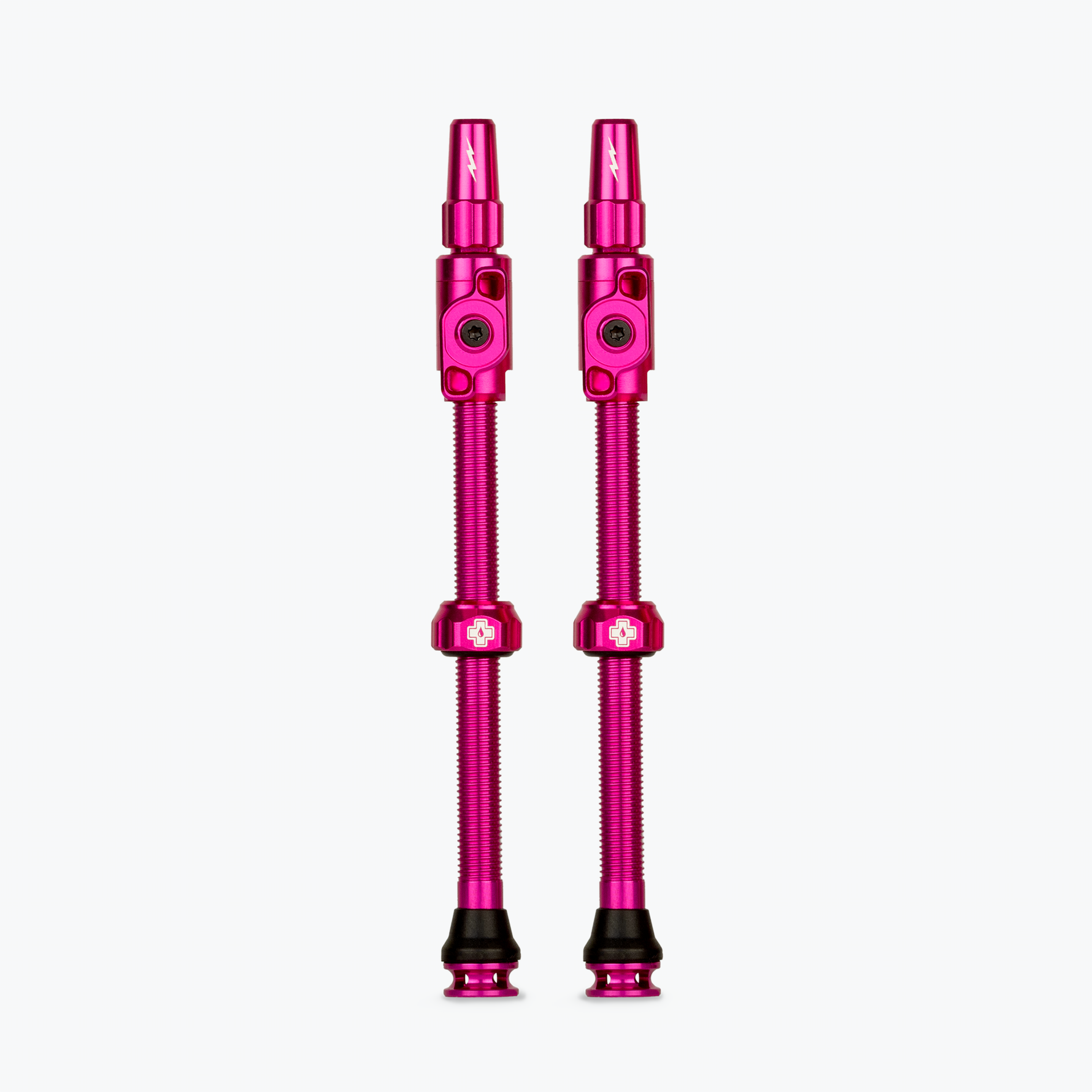 Pair of pink Muc-Off Big Bore Lite tubeless Presta valves on white background