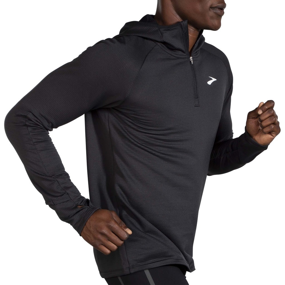 Man wearing Brooks Notch Thermal Hoodie in heather ash gray with quarter-zip