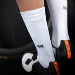 White Gobik cycling socks with black logo worn during cycling