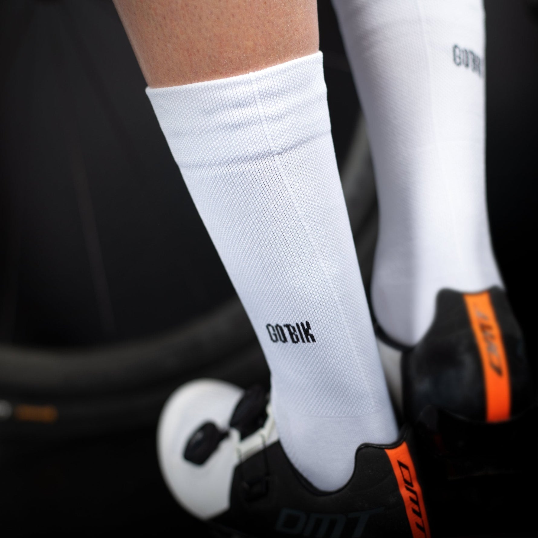 White Gobik cycling socks with black logo worn during cycling