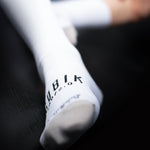 White Gobik Iro 2.0 cycling socks with black logo branding on ankle