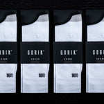 Four packages of white Gobik socks with black branding in product packaging